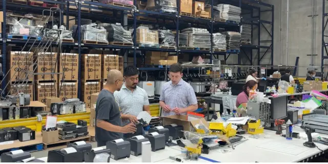 IW employees working in the warehouse
